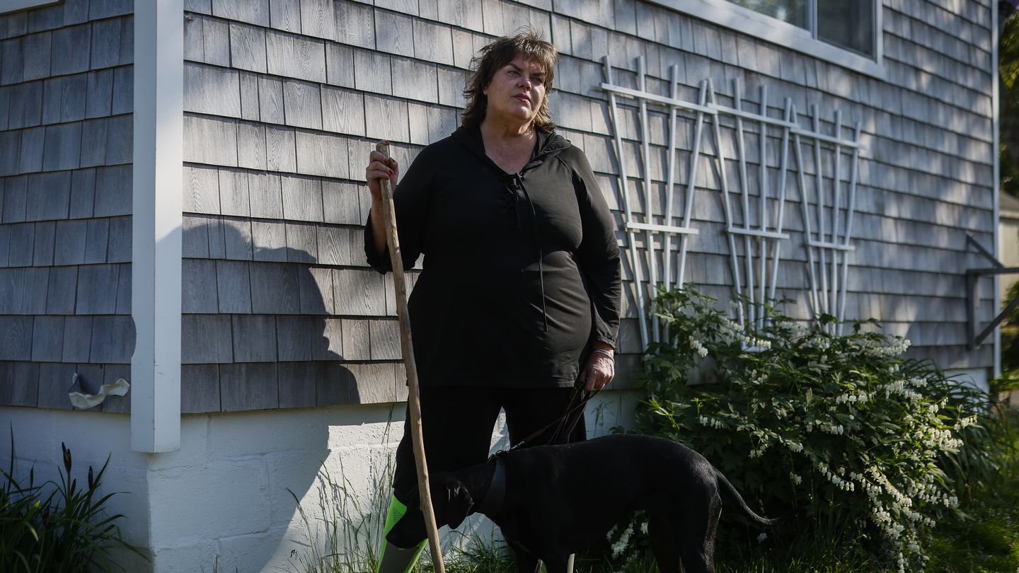 Sarah Buck stood with her service dog, Little Bit. Buck, a SNAP recipient, is one of thousands of 50- to 55-year-olds in Massachusetts whose food assistance benefits could be impacted by the debt ceiling agreement.