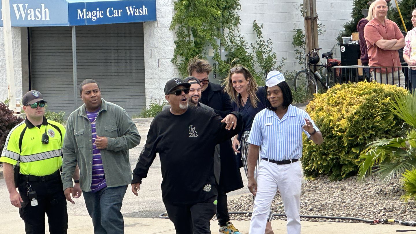 Kenan Thompson and Kel Mitchell cross Mineral Spring Avenue in North Providence, Rhode Island, on Friday, May 19, 2023, with security, to meet fans.