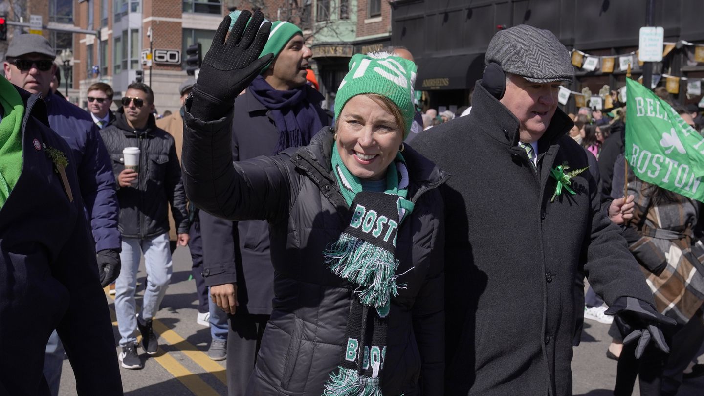 Governor Maura Healey, center, waves to spectators while marching in the St. Patrick's Day parade in South Boston in March.