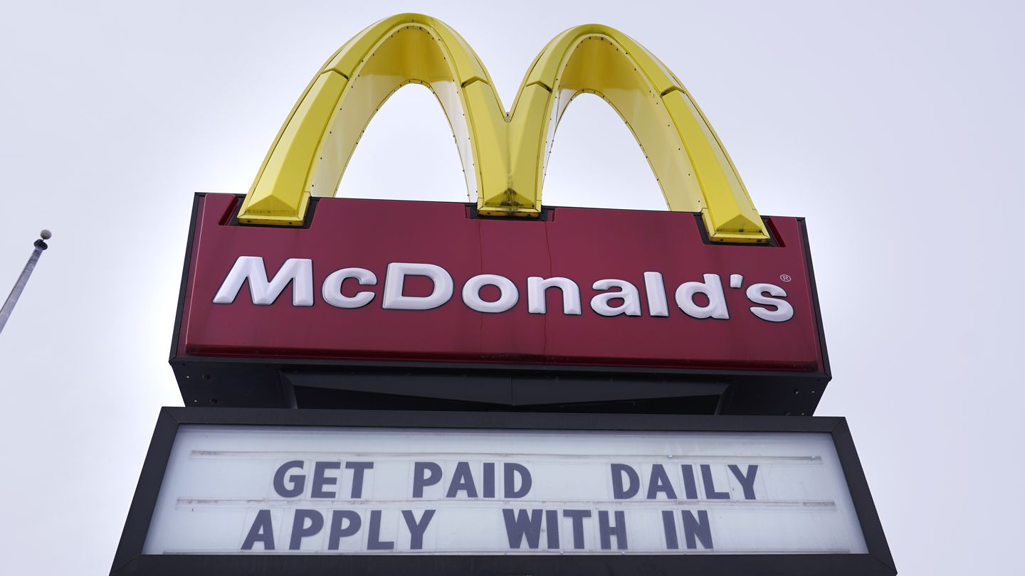 A sign outside a McDonald's restaurant offers prospective workers an opportunity to get paid daily for their employment, Monday, Feb. 27, 2023, in Salem, N.H.