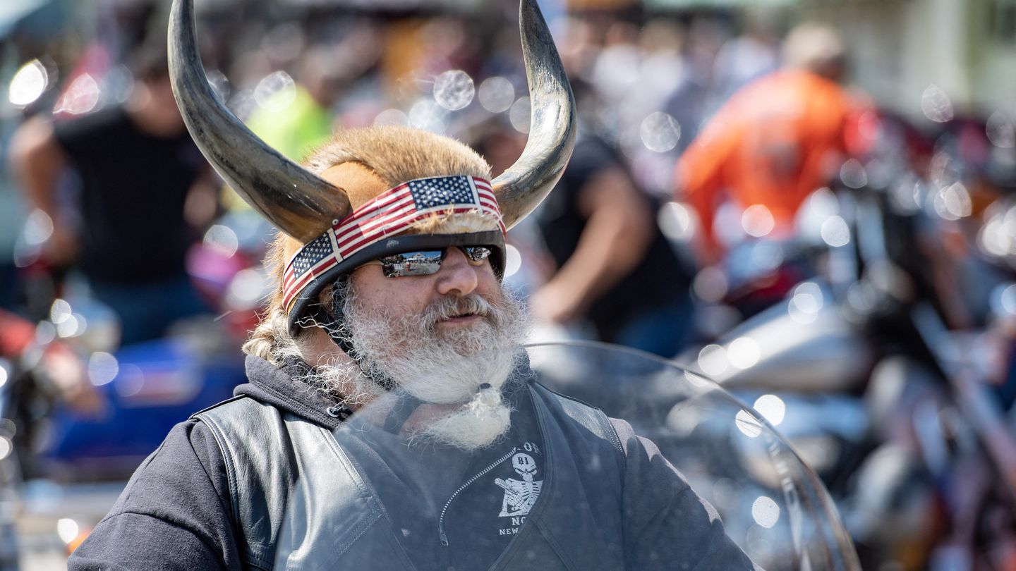 A motorcyclist wearing horns on their helmet rides their bike during the 100th anniversary of the Laconia Motorcycle Week in Laconia, New Hampshire, on June 11, 2023. The rally, which is expected to bring in over 300,000 motorcyclists, is considered to be the oldest in the US. The event runs from June 10 to June 19.
