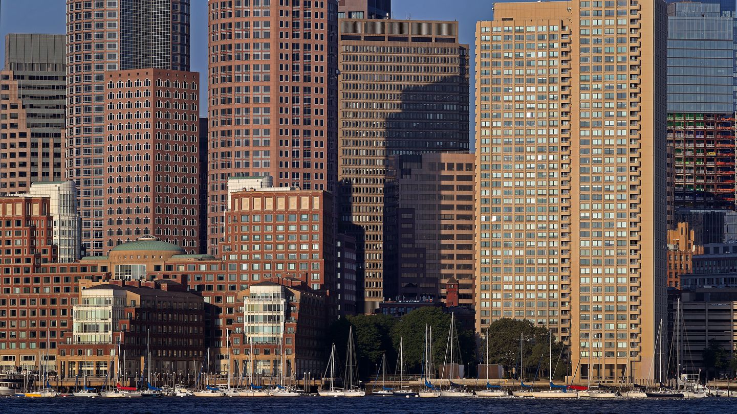Boston's waterfront viewed from Boston Harbor in the early morning light, August 2022.