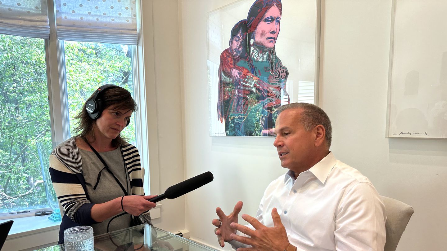 US Representative David N. Cicilline, a Rhode Island Democrat, speaks during the recording of the Rhode Island Report podcast at his Providence home as producer Megan Hall holds a microphone.