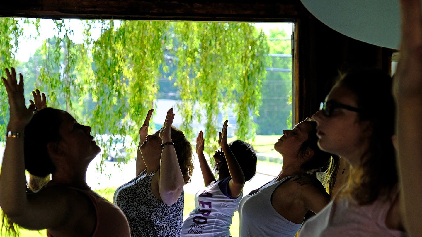 Mothers practicing yoga at the Wellness Barn at New Generation, a family-oriented shelter for homeless pregnant women and their babies in Greenland, N.H.