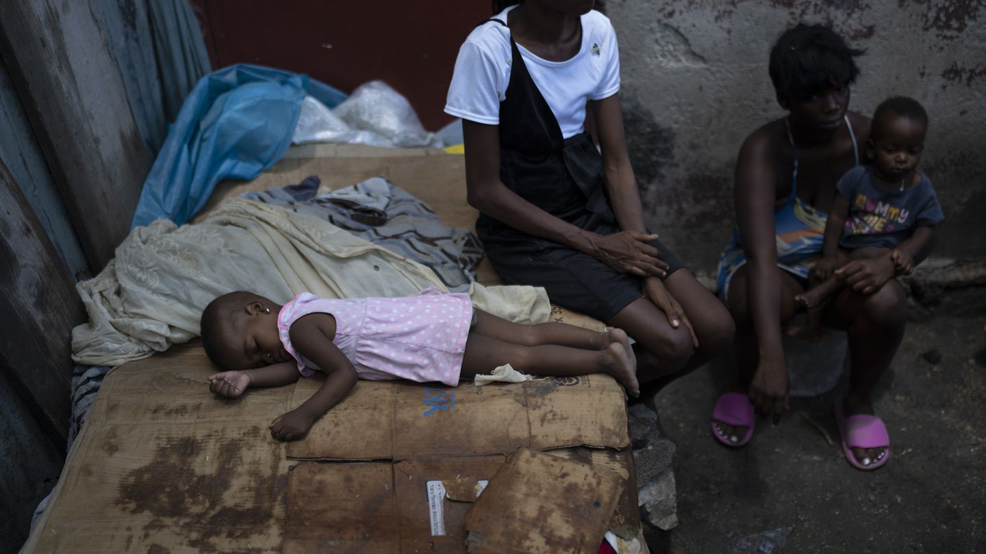 People displaced by gang violence from the area of Cite Soleil sit at a makeshift shelter in Port-au-Prince on June 4.