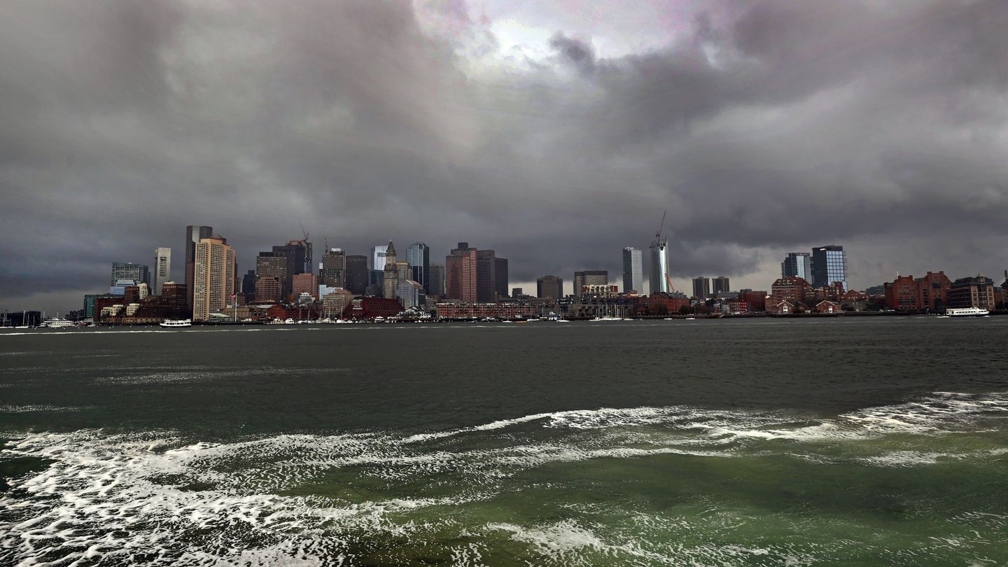 Boston skyline under some early morning storm clouds viewed from Boston Harbor.